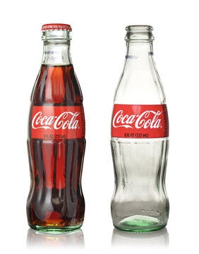 Empty and full Coca Cola glass bottles Stock Photo | Adobe Stock