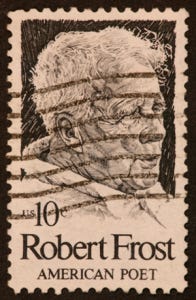Postage stamp 10¢ with image of a man and the words "Robert Frost, American Poet"