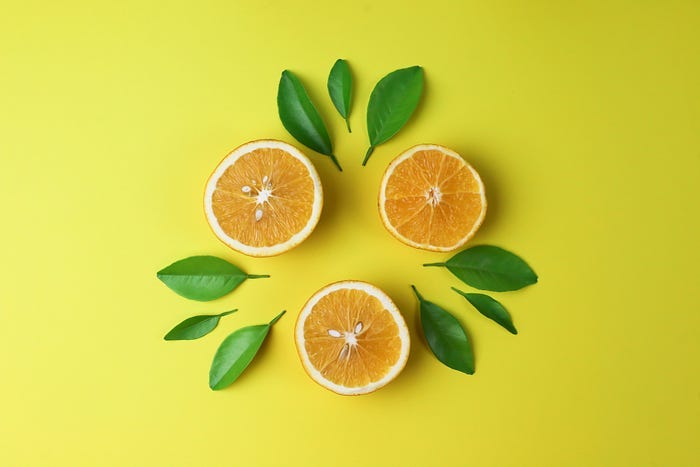 three half lemons on a yellow background