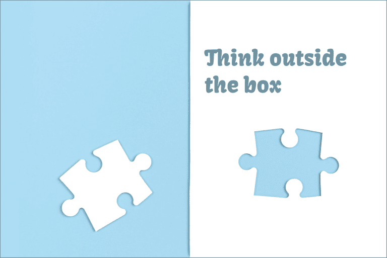 Two puzzle pieces on a blue background with the text 'Think outside the box'
