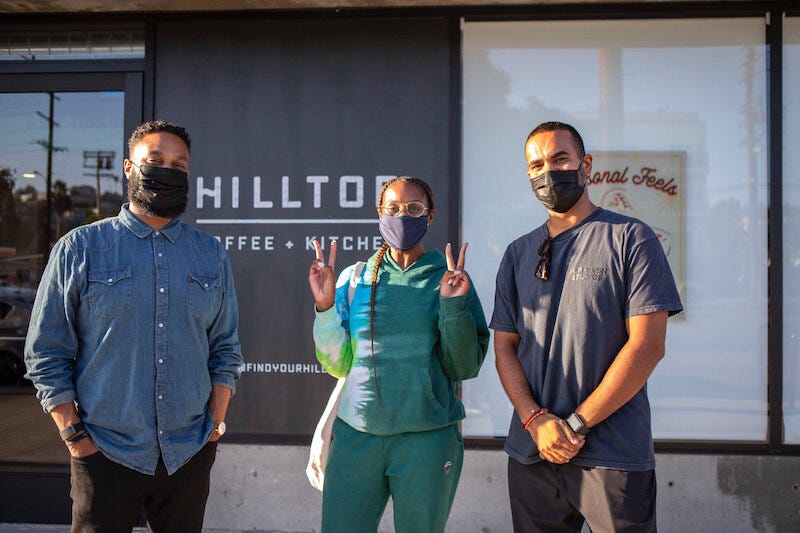 Issa Rae (center), with Hilltop Coffee founders Yonnie Hagos (Left) & Ajay Relan (Right) in front of their newly opened shop. 