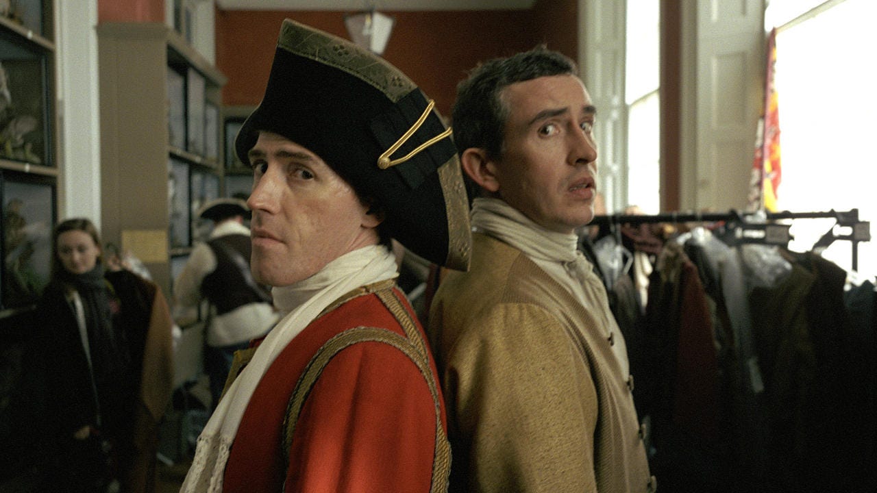 Rob Brydon and Steve Coogan stand back to back in costume for Tristram Shandy: A Cock And Bull Story