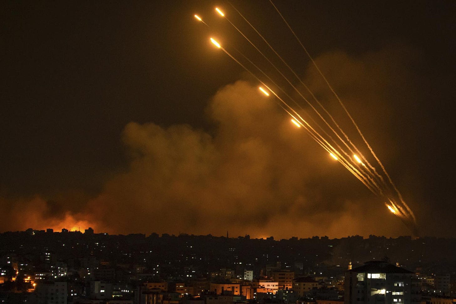 Rockets are fired toward Israel from the Gaza Strip, Sunday, Oct. 8, 2023. 