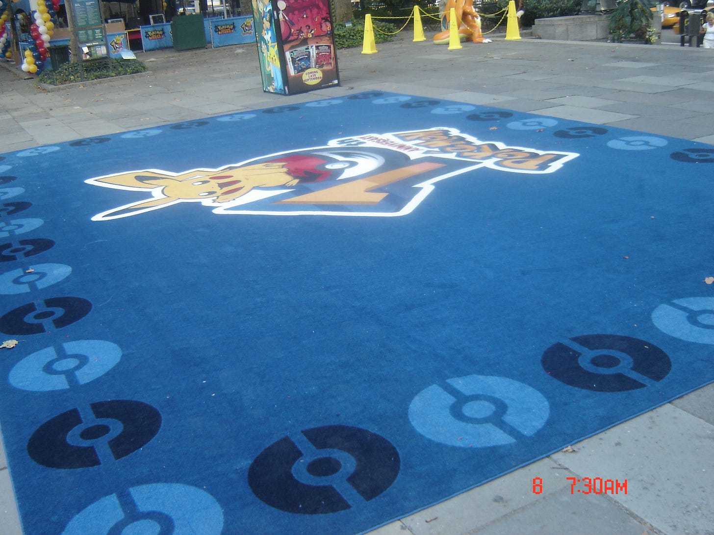 A large blue mat with the Pokémon 10th anniversary logo