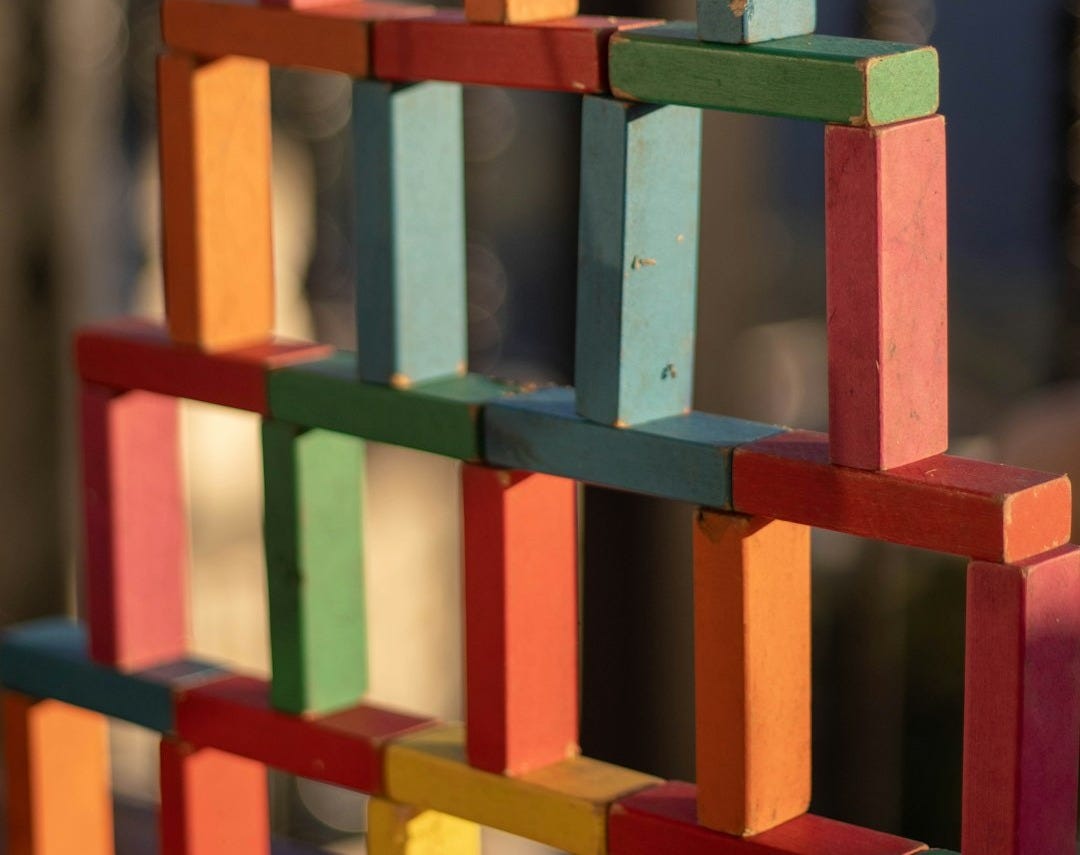 a multicolored building made of wooden blocks a multicolored building made of wooden blocks