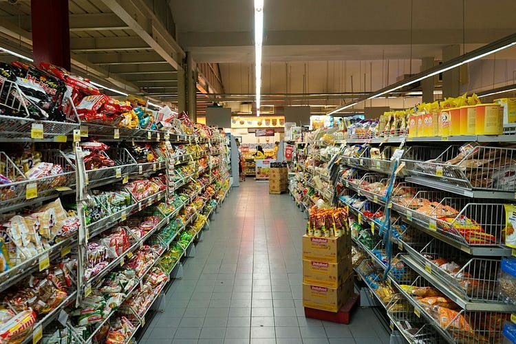 Photograph of a large aisle in a large store.