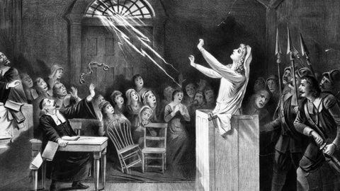 Black and white drawing of woman on the stand during the Salem Witch Trials.