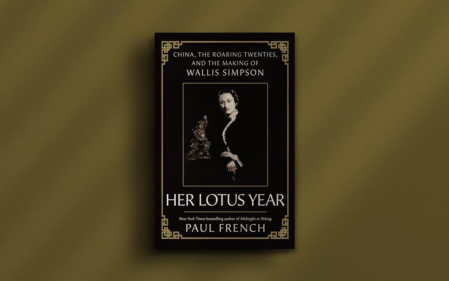 Image shows the front cover to Her Lotus Year, by Paul French. Black and gold border framing a portrait of Wallis Simpson, a white woman in Chinese dress posing next to a statue. Text at the top reads, ‘China, the Roaring Twenties and the making of Wallis Simpson.