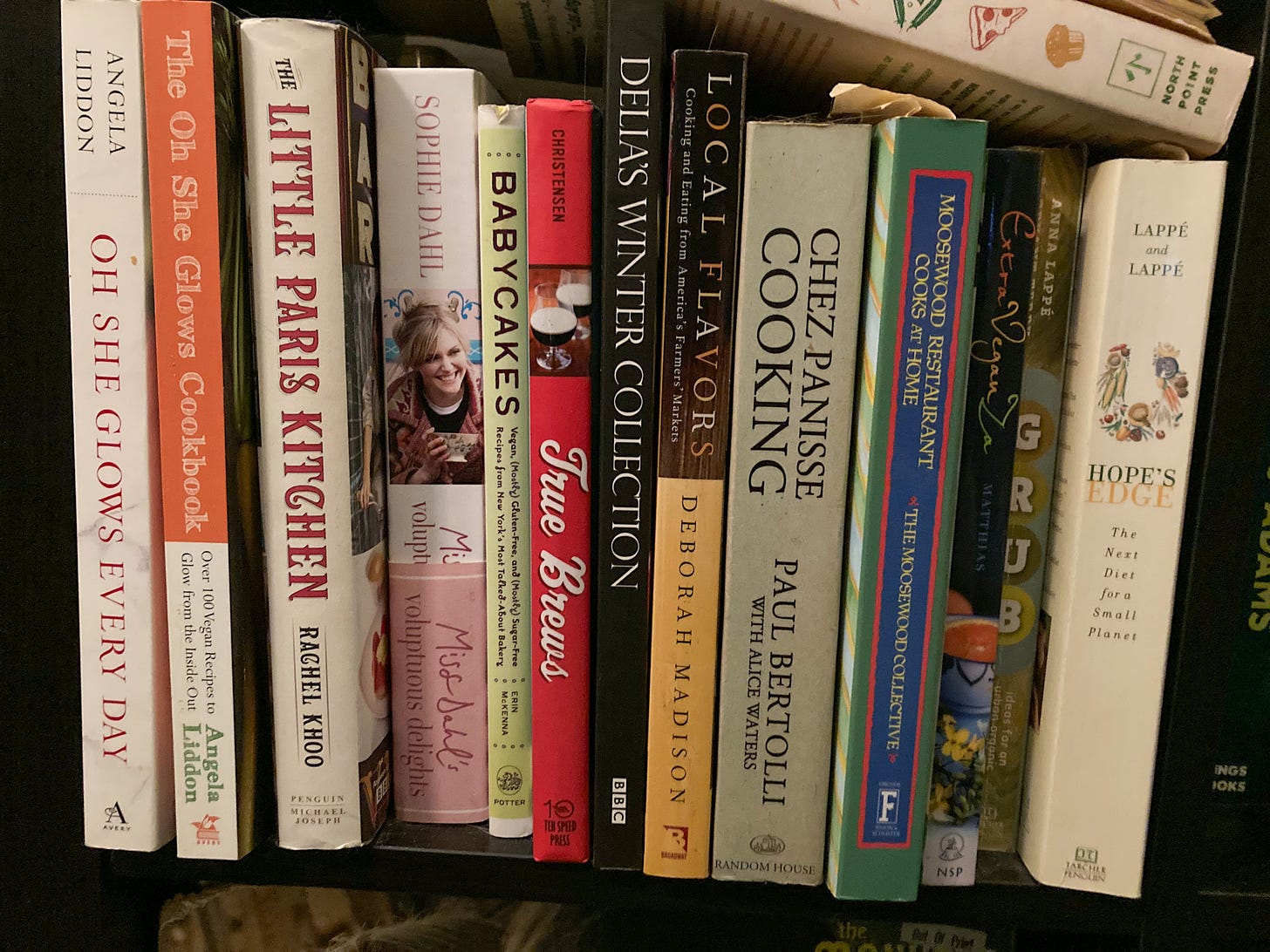 a shelf with cookbooks and books about food