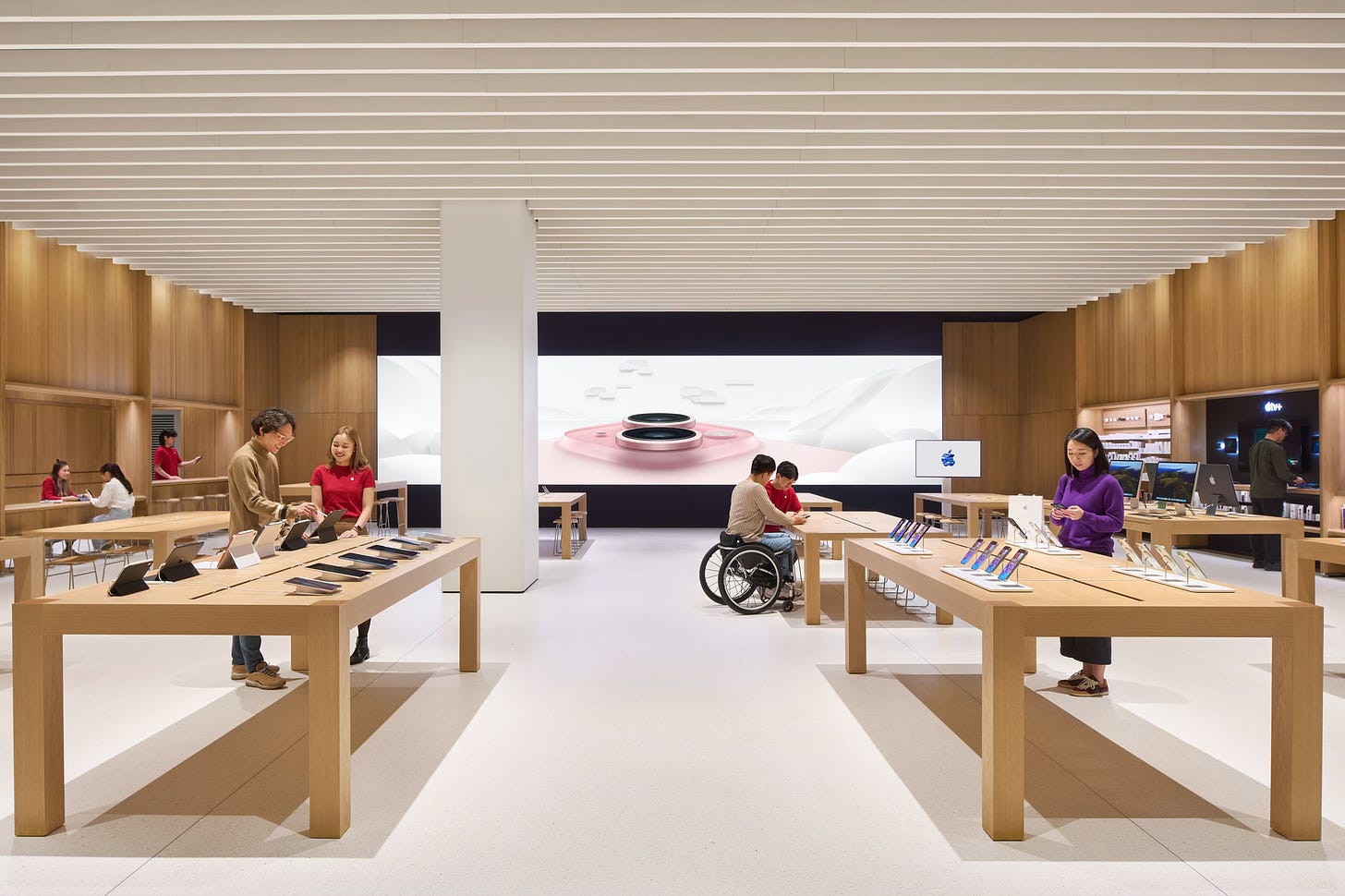 The interior of Apple Hanam. A large fabric graphic panel fills the back wall of the store.