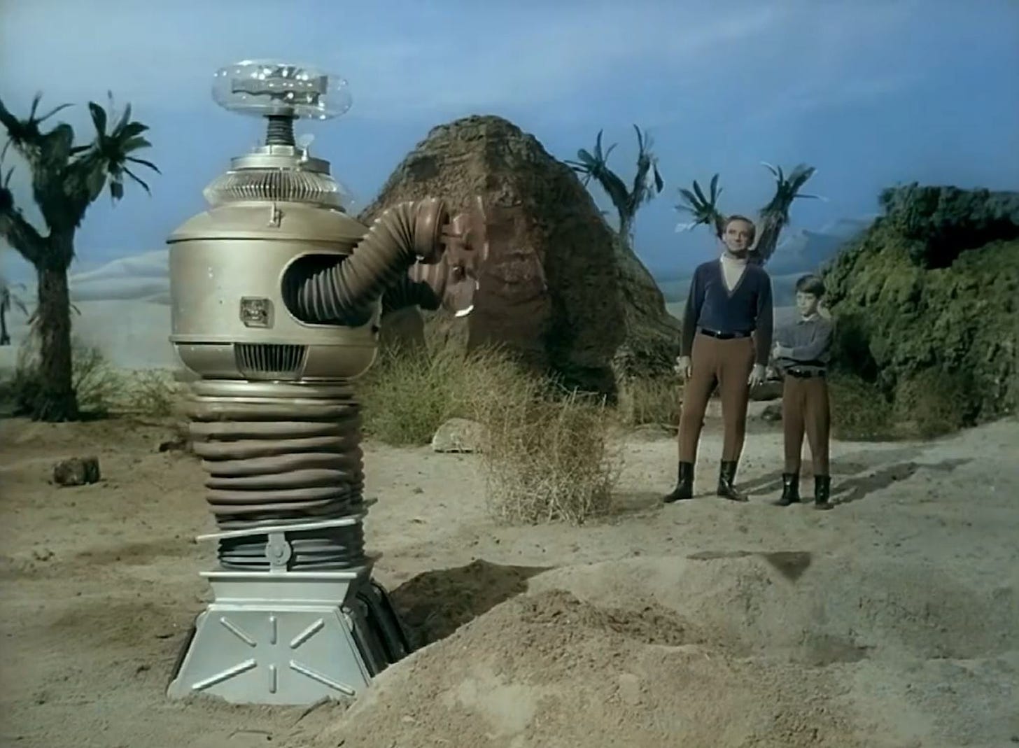 The robot with Dr. Smith and Will in a Season 1 episode of Lost in space.