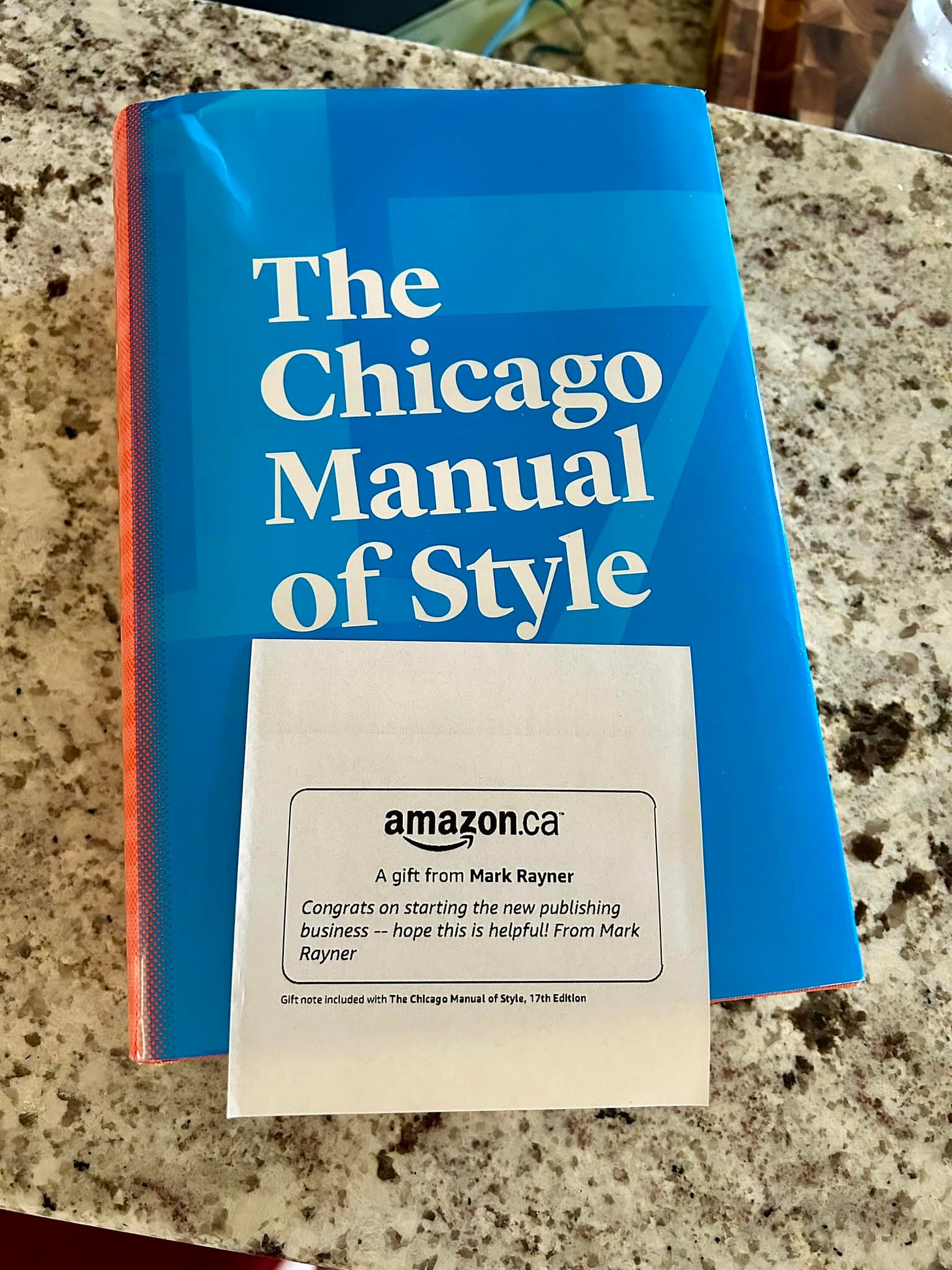 A copy of the Chicago Manual of Style along with a card from Amazon indicating it's a gift from Mark A Rayner