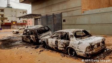 Destroyed vehicles are pictured outside the burnt-down headquarters of Sudan's Central Bureau of Statistics