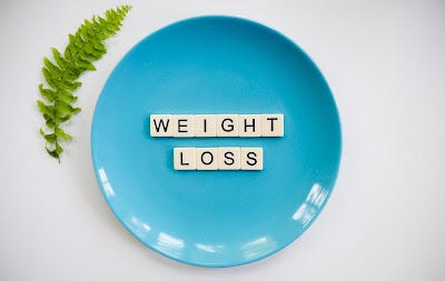 weight loss, blue plate with letters on spelling out weight loss