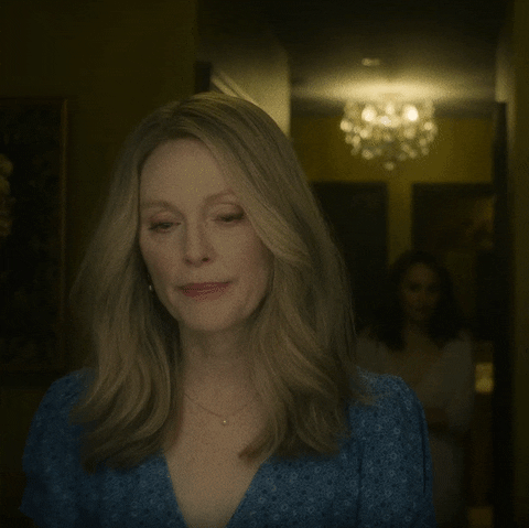 Animated gif from 2023 film May December. In the foreground Julianne Moore as Gracie. Over her shoulder her Natalie Portman as Elizabeth approaches