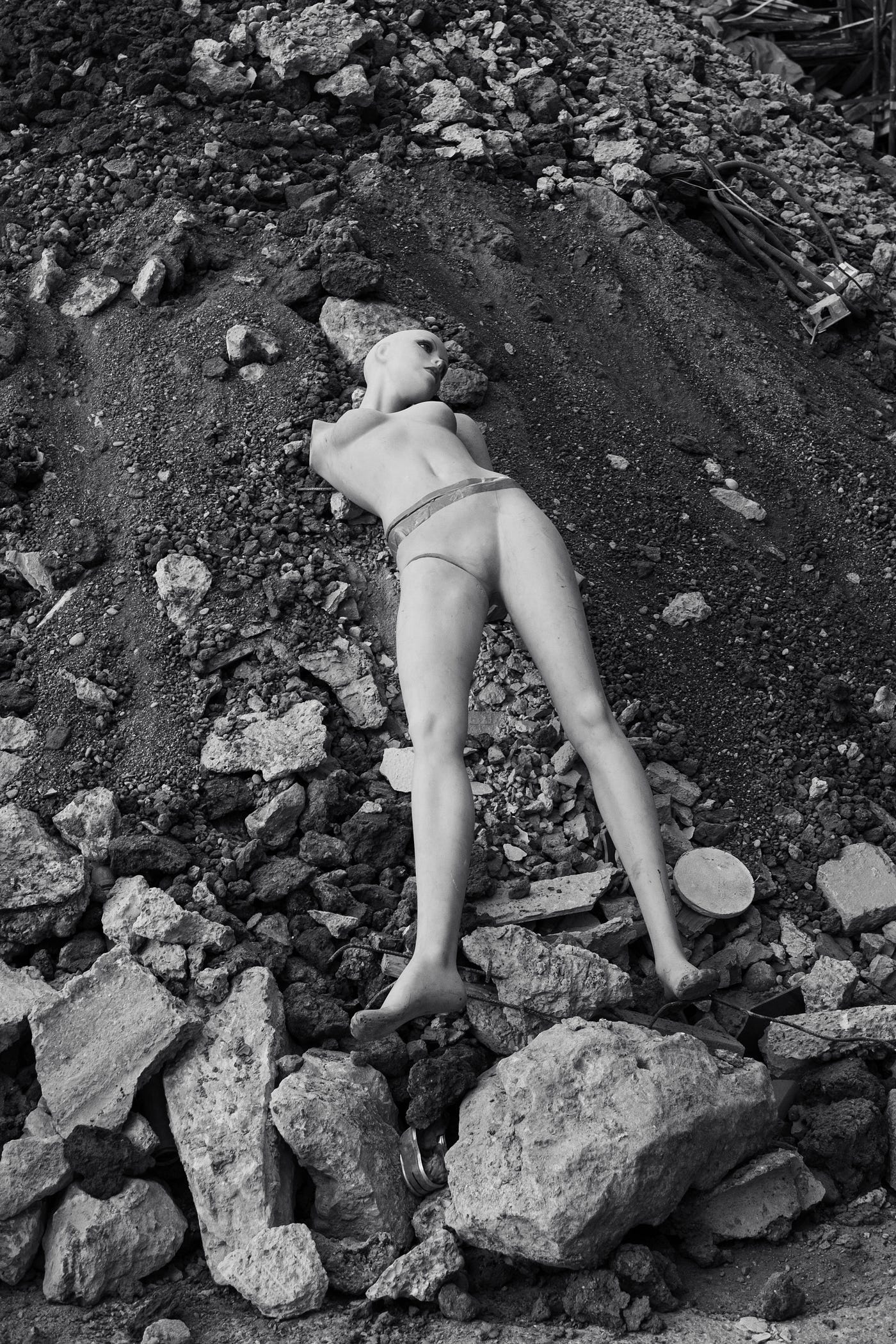 A photo of a doll in a landfill.