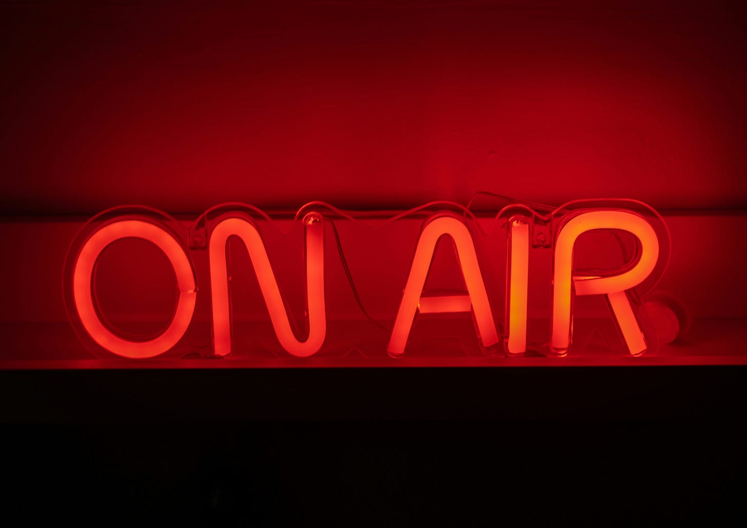 A red neon sign that says "ON AIR"