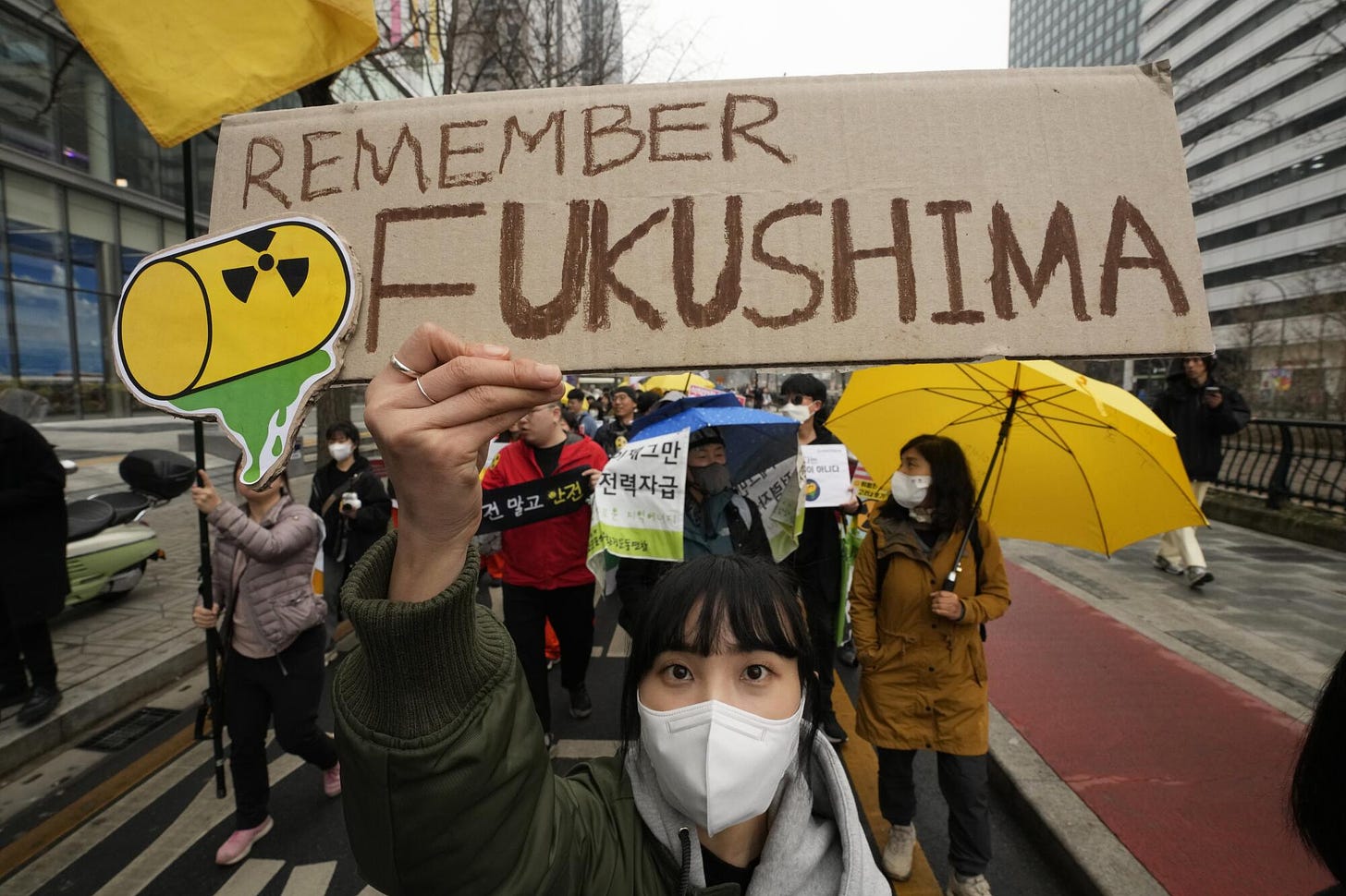 Environmental activists march during a rally marking the 12th anniversary of the Fukushima nuclear disaster.