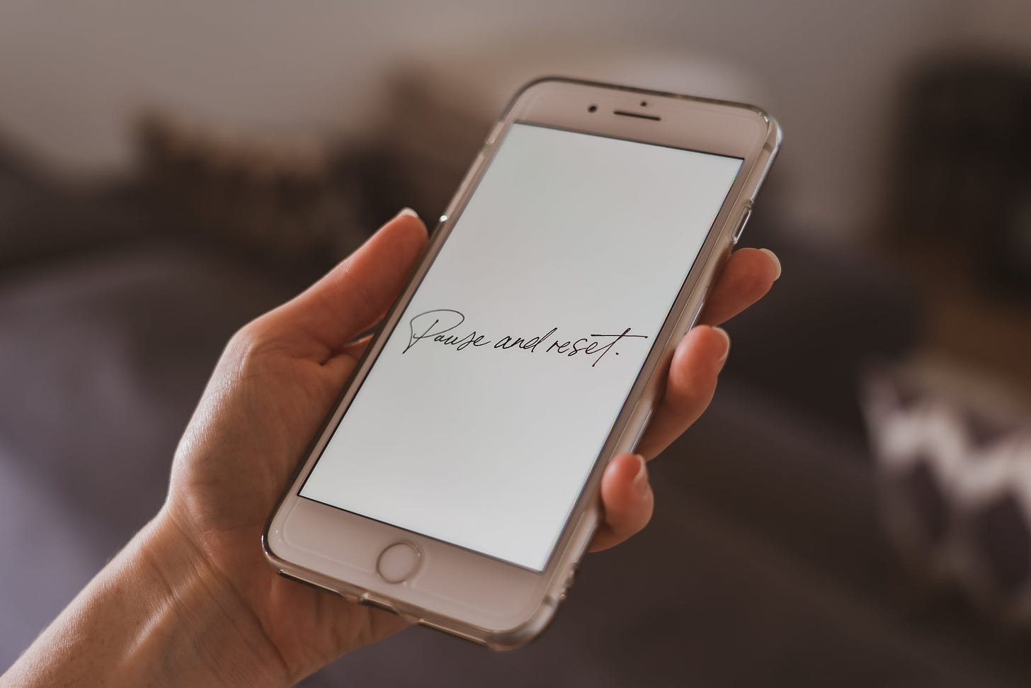 "Pause and reset" written in cursive on phone's display