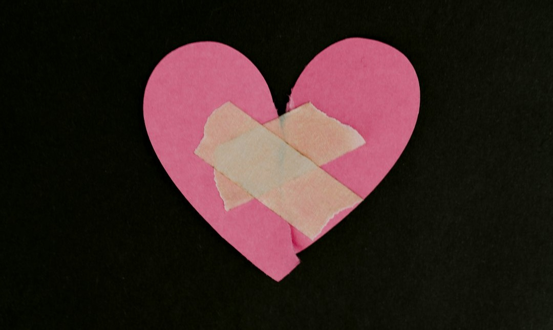 a pink heart cut out of a piece of paper