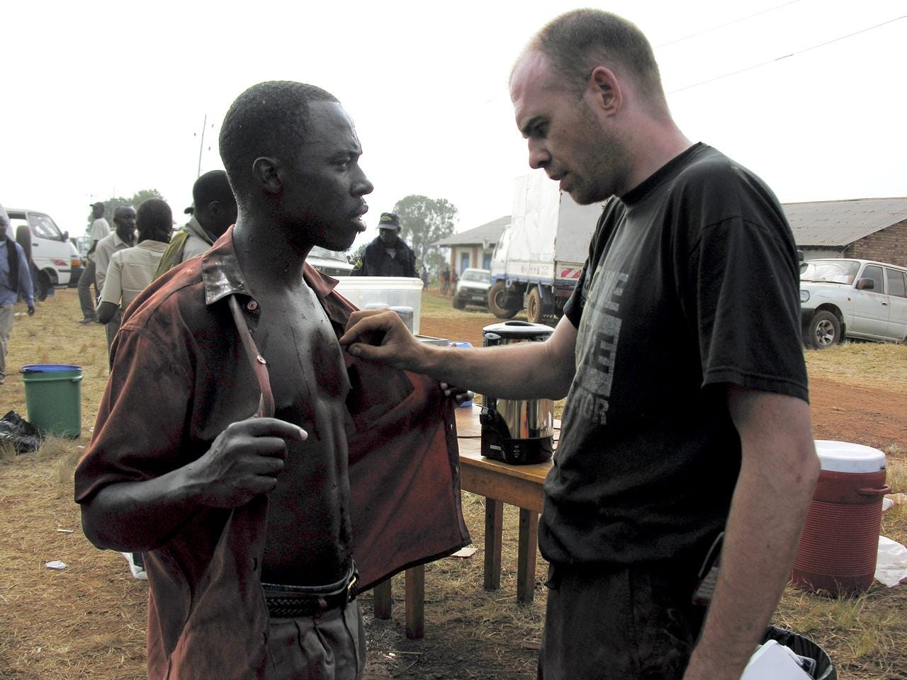 A.S. Hamilton applies makeup to an actor on set in Rwanda.