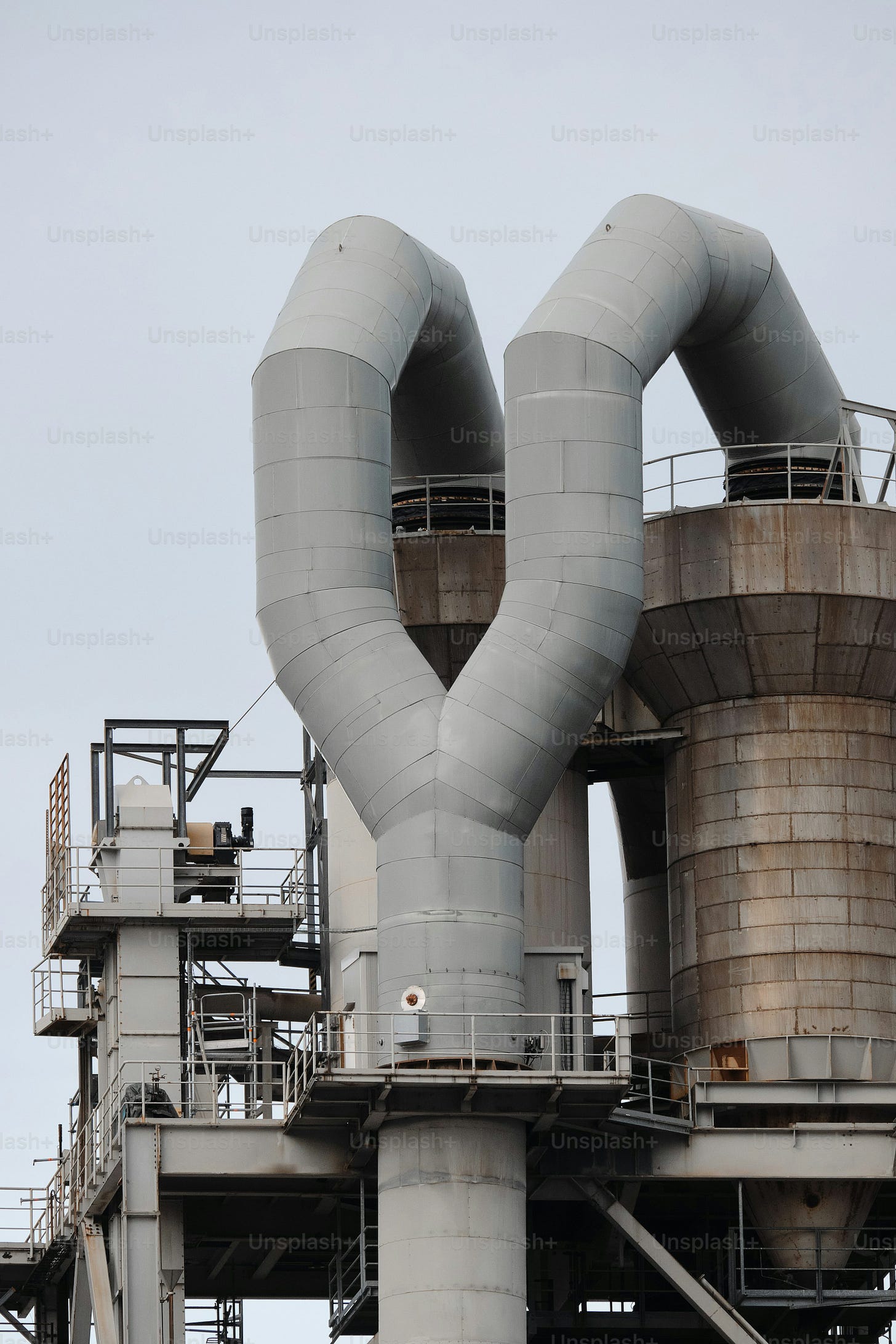 a large industrial building with pipes and pipes on top of it