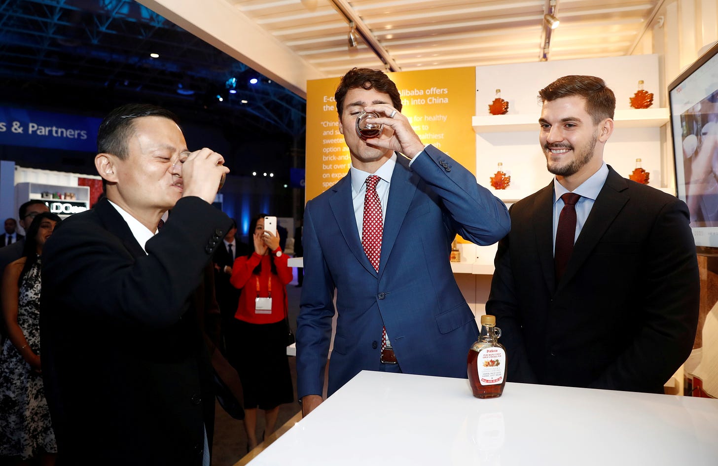 Canada's PM Trudeau and Alibaba founder Ma try a sample of maple syrup the Gateway Conference in Toronto