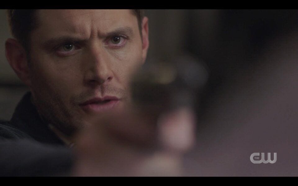 Jensen Ackles Dean holding intense gun on brother Sam Unity