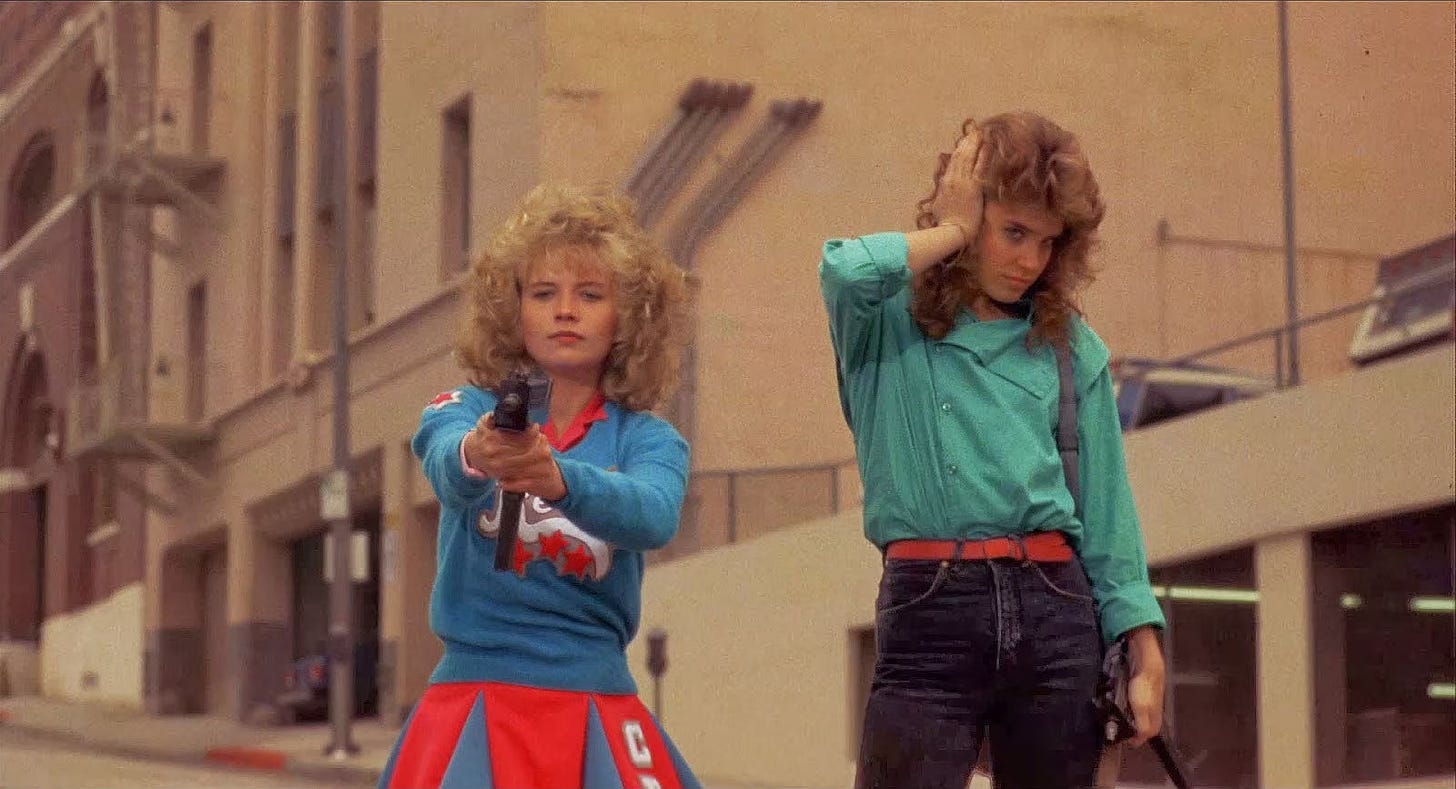 Catherine Mary Stewart (striking a pose) and Kelli Maroney (holding a gun) as Reggie and Sam Belmont in Night of the Comet. 