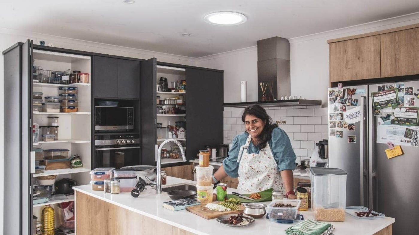 Perzen Patel in her kitchen with food on the counter top.