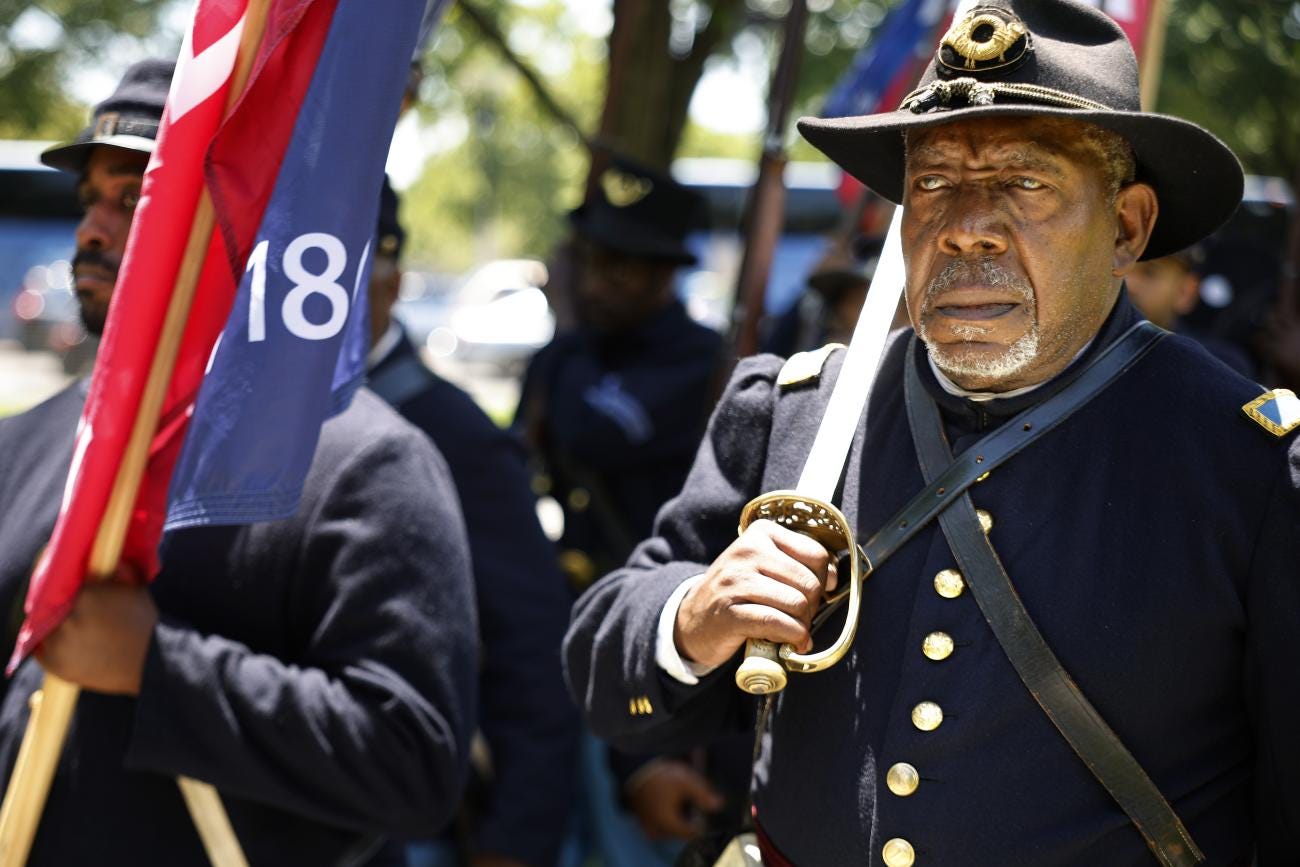 2nd Lt. James Hayes Jr. of the 54th Regiment of the U.S. Colored Troops, Company K from Atlanta, Georgia, leads a group of fellow historic re-enactors during the Juneteenth People's Parade on June 19, 2024 in Washington, DC.