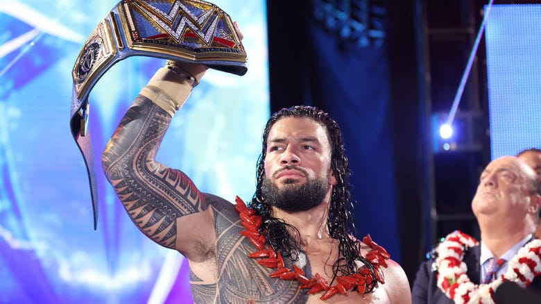 Roman Reigns holding up the WWE Universal Championship
