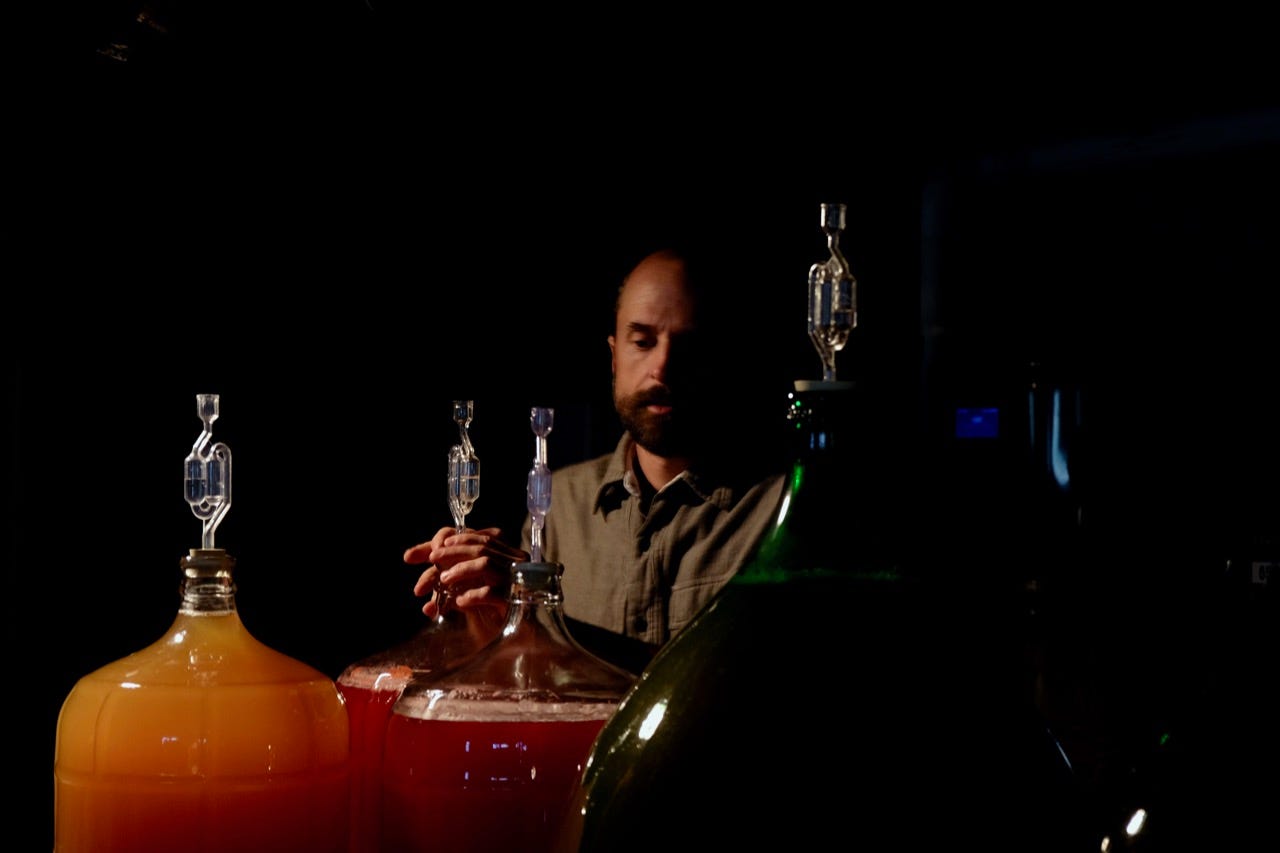 Teddy Weber checking fermentations at his home Tin Hat cidery in Roxbury, Vermont