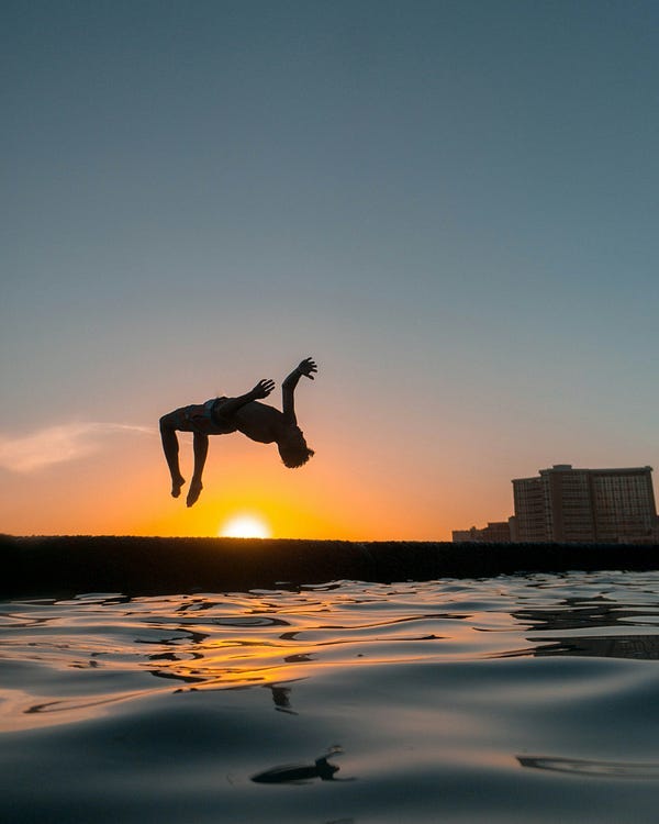 person leaping in the sea.