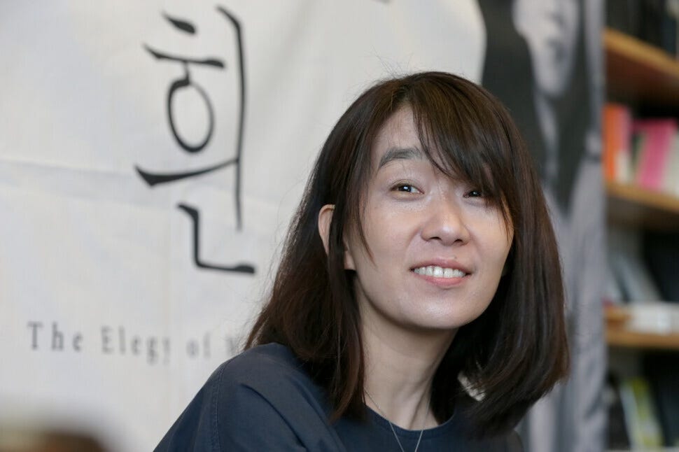 Photo of novelist Han Kang smiling in Seoul, Korea, after winning 2016 Booker Prize