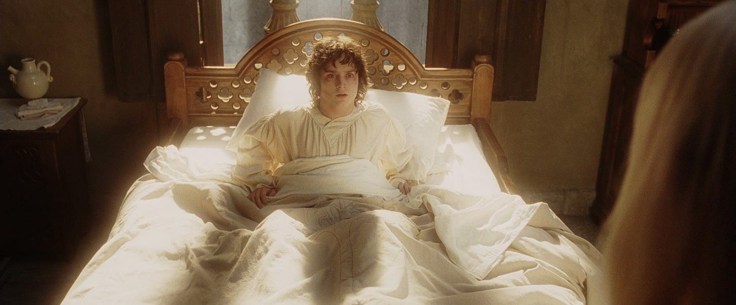 Frodo wakes in a white bed in soft lighting