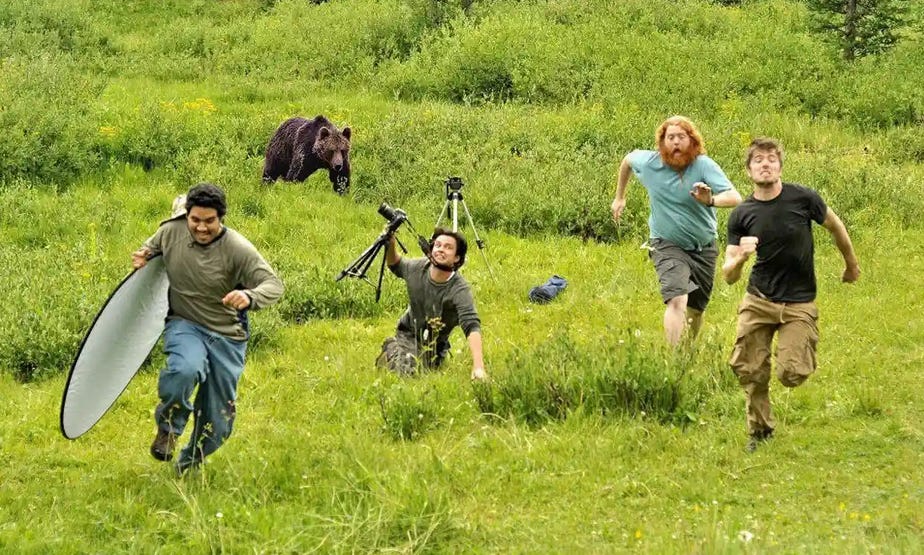 A bear chasing a camera crew, about to either eat or fire them