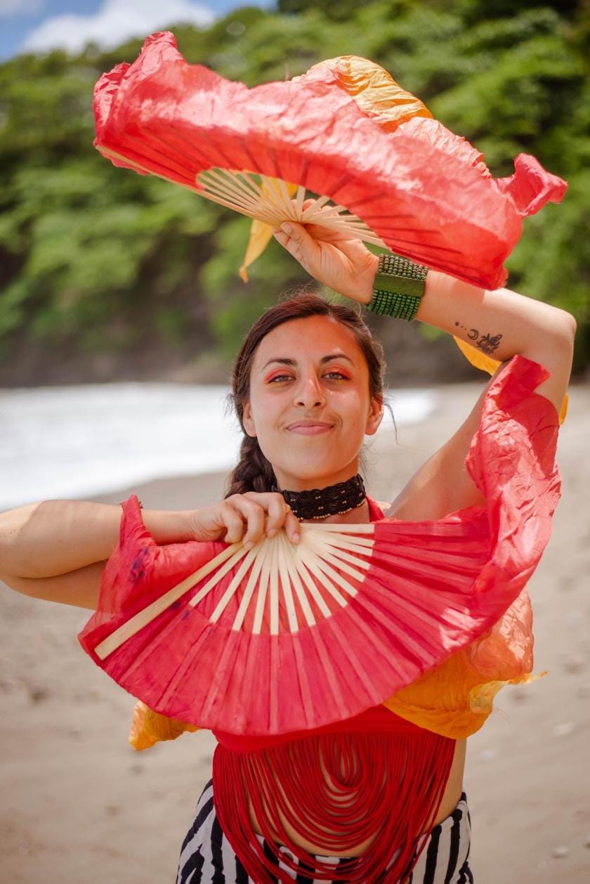 A person dancing with a fan

Description automatically generated
