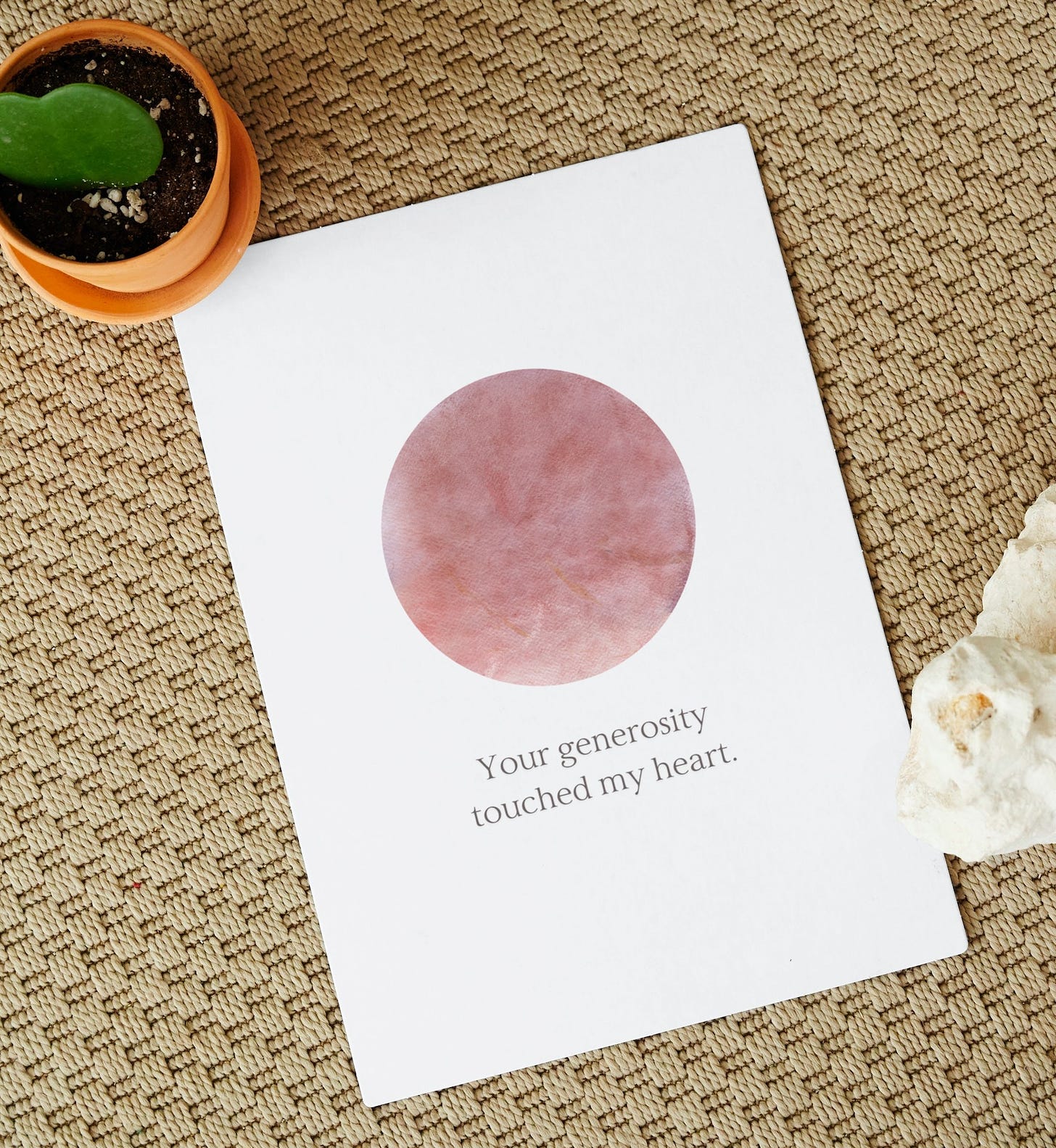 A greeting card with an abstract circle that reads 'Your generosity touched my heart.' It does not say thank you.