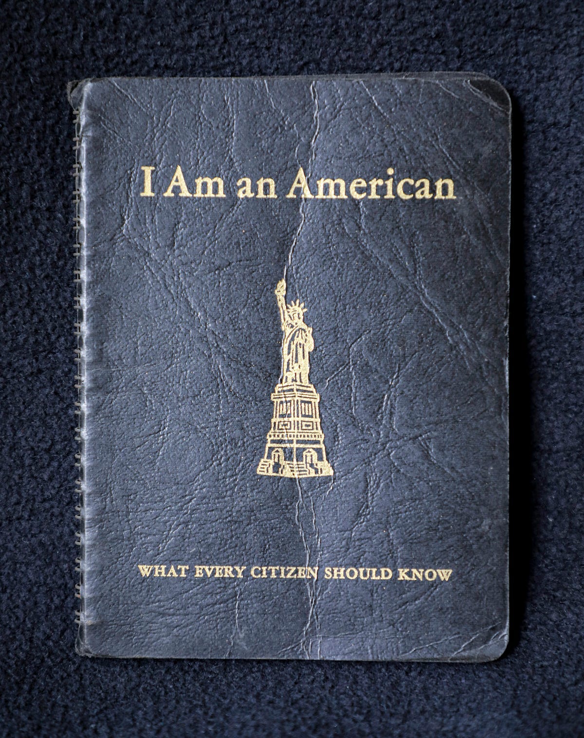 Old notebook with “ I Am an American” written on the cover.