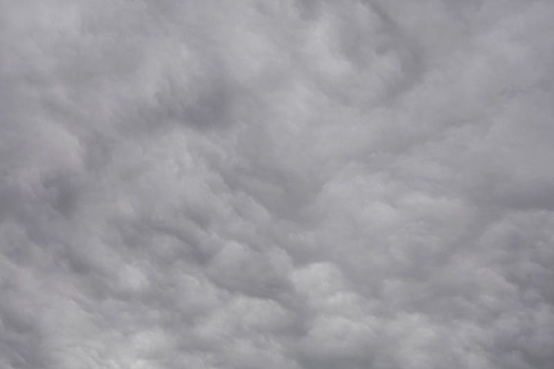 Grey clouds resemble woodsmoke in turbulent air