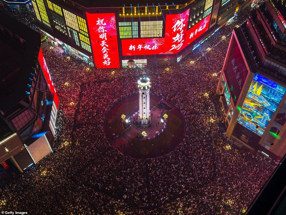 CHONGQING: A high-angle view shows thousands of people gathering at Jiefangbei Pedestrian Street for New Year's Eve celebrations, with bright neon lights, banners wishing "Happy New Year," and the iconic Liberation Monument illuminated, on January 01, 2025, in Chongqing, China