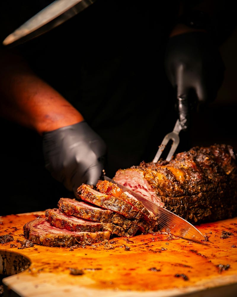 Slicing a portion of roast.