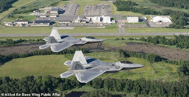 Above, two USAF F-22 Raptors fly over Joint Base Langley-Eustis in Virginia on June 14, 2018