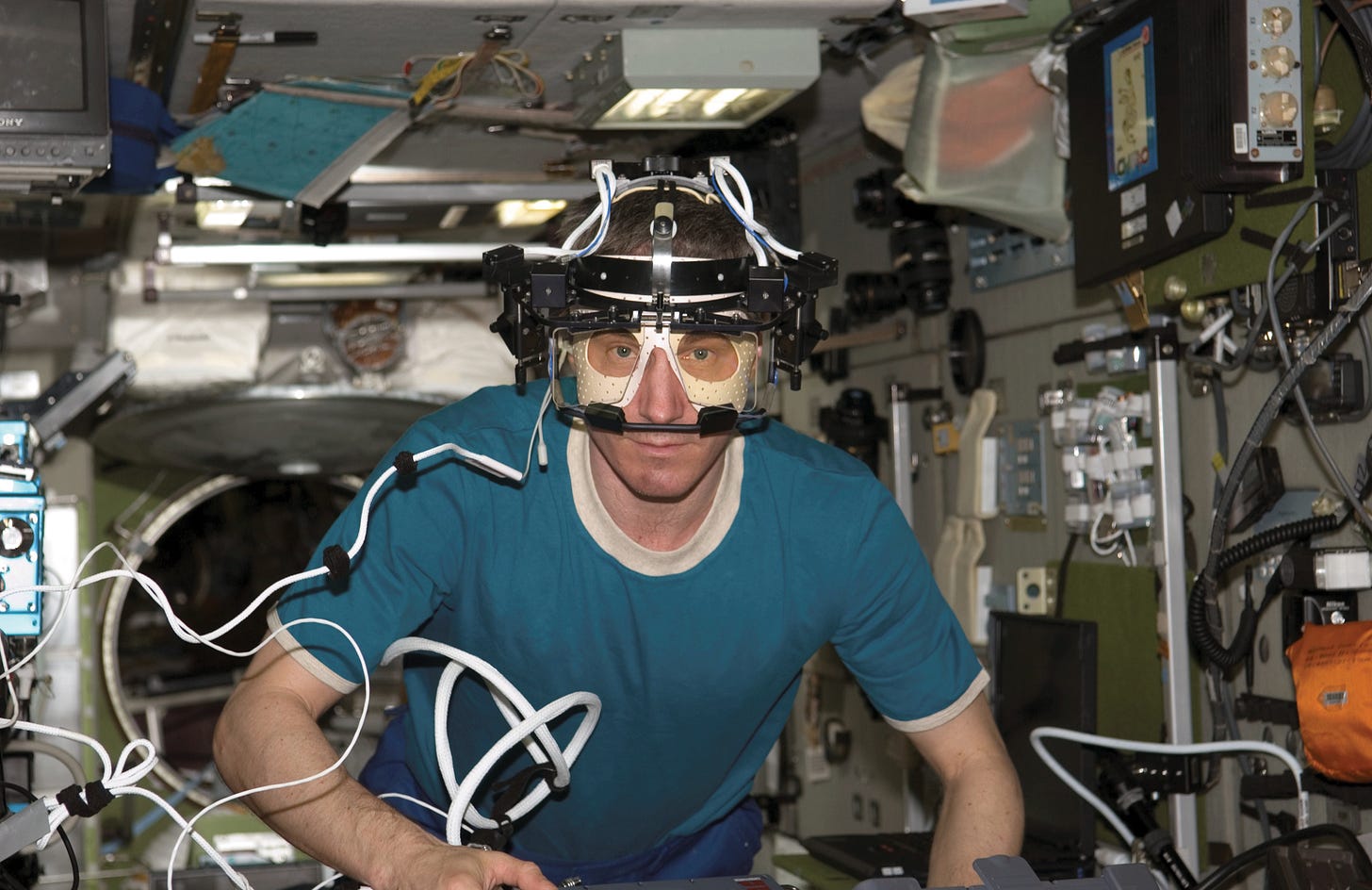 image of astronaut wearing eye testing device image of astronaut wearing eye testing device