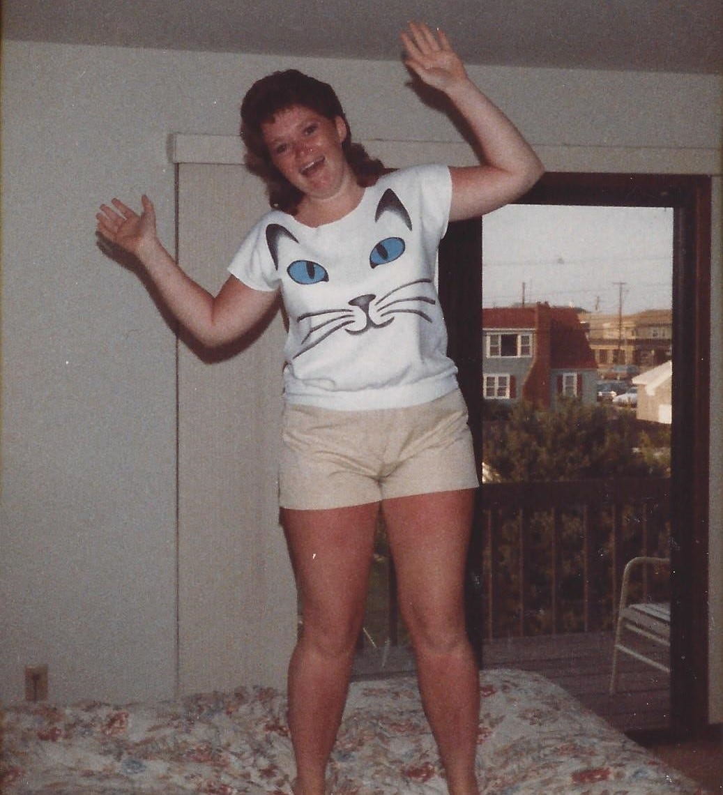 Girl in her late teens jumping joyfully on a bed