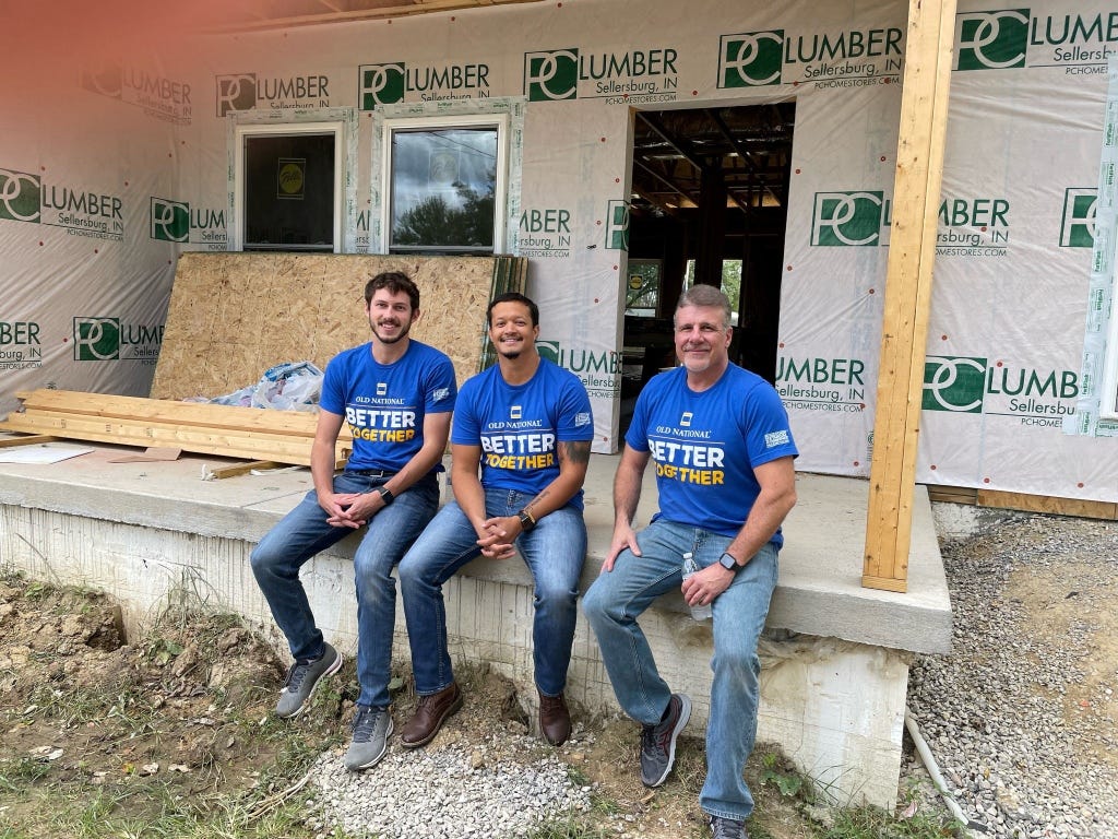 This photo taken in September 2022 shows Louisville mass shooter Connor Sturgeon, far left, smiling while doing volunteer work. The man on the far right is his colleague Troy Haste.