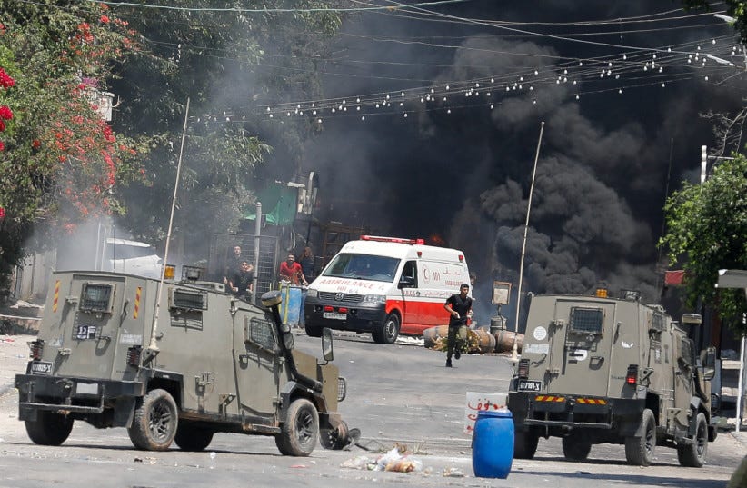  Palestinians clash with Israeli forces during an Israeli military operation in Jenin, in the West Bank July 3, 2023 (photo credit: REUTERS/RANEEN SAWAFTA)