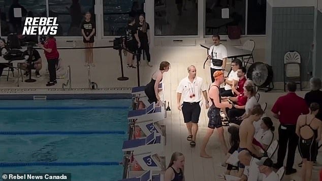 They claimed parents used towels to setup a makeshift tent to protect the girls that had to change in front of Wiseheart, seen in orange swim cap at the meet earlier this month
