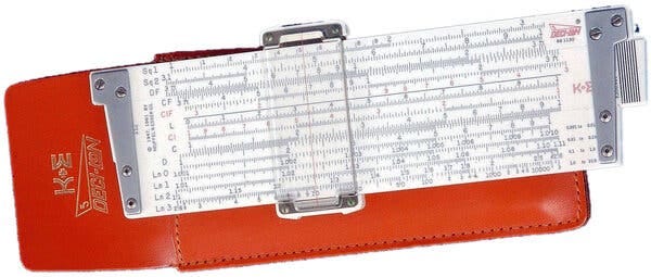 A rectangular white plastic slide rule with its red leather case behind it. 